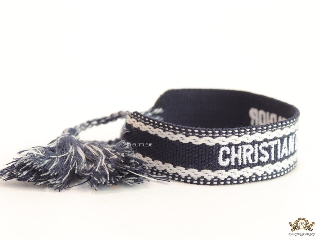 Adjustable dark grey woven bracelet with knitted alphabets and tassels