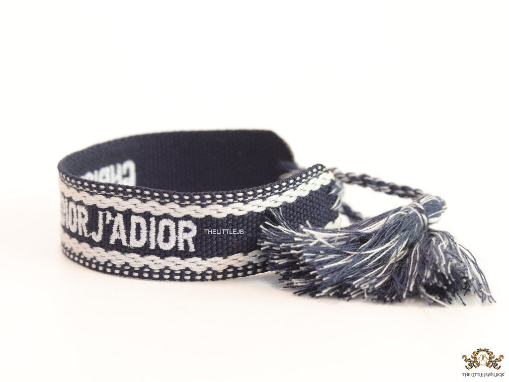 Adjustable dark grey woven bracelet with knitted alphabets and tassels