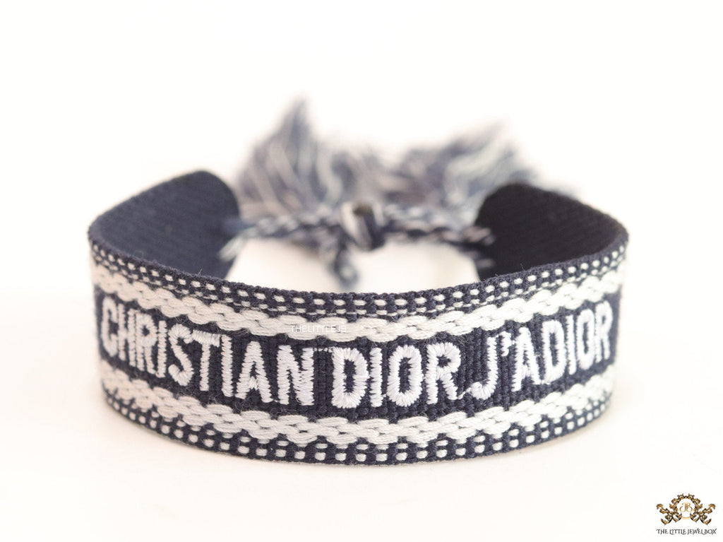 Adjustable dark grey woven bracelet with knitted alphabets and tassels