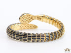 snake open bracelet in black and golden finish