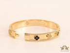 Gold plated bracelet with clover motifs in cz and black enamel