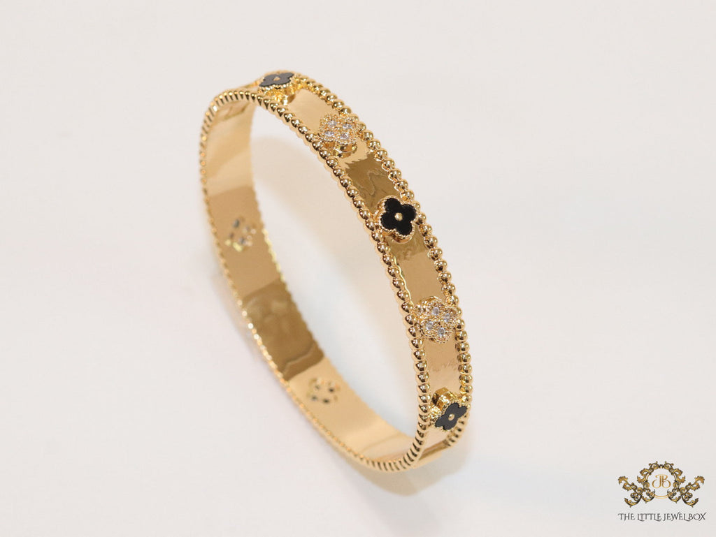 Gold plated bracelet with clover motifs in cz and black enamel