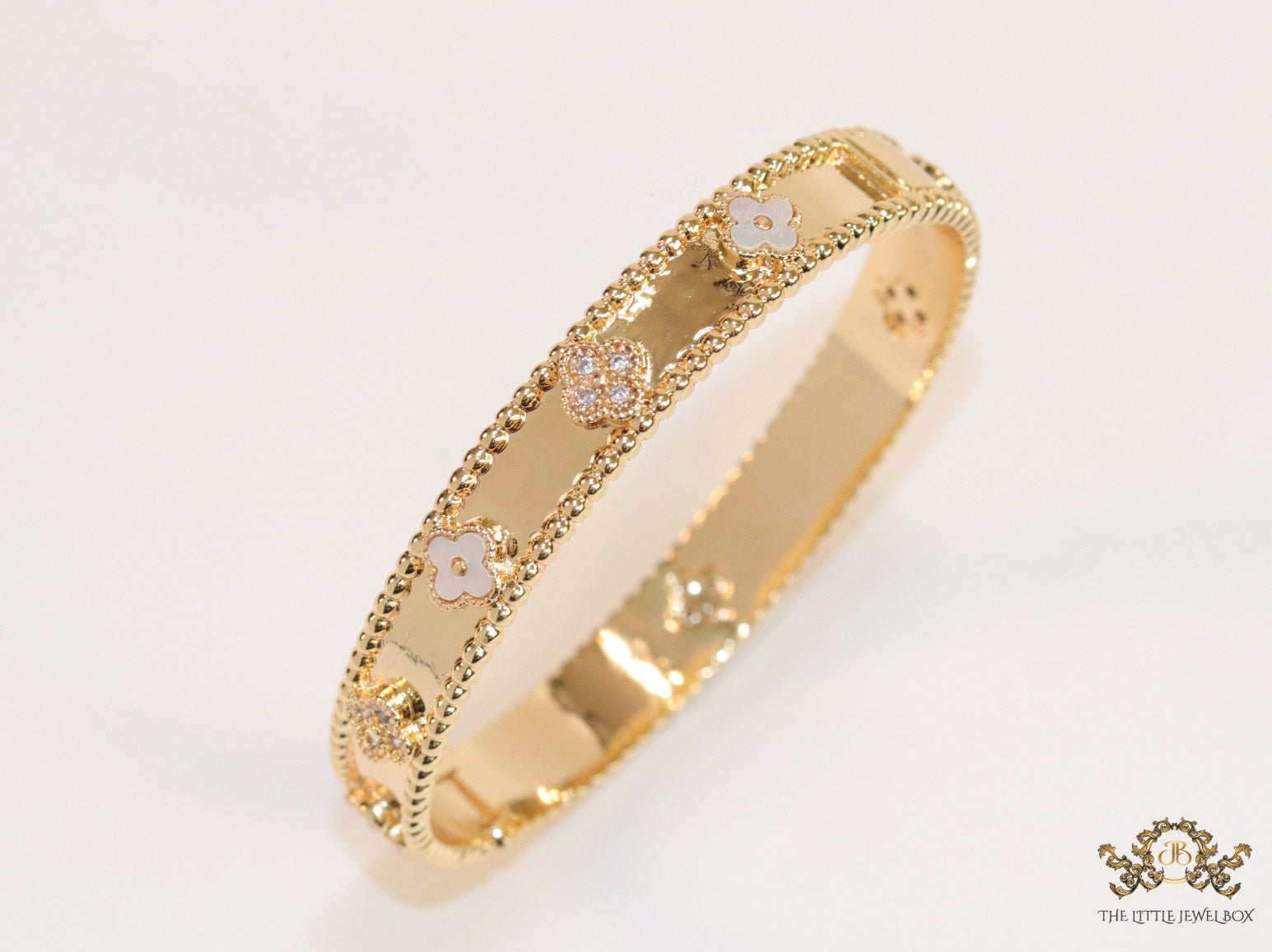 Gold plated bracelet with clover motifs in cz and MOP