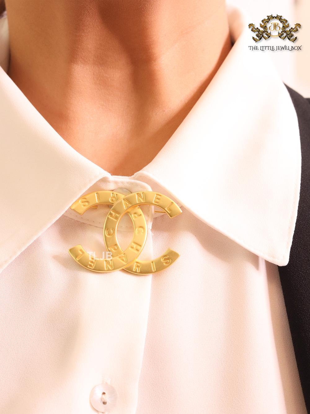 Double C embossed gold brooch