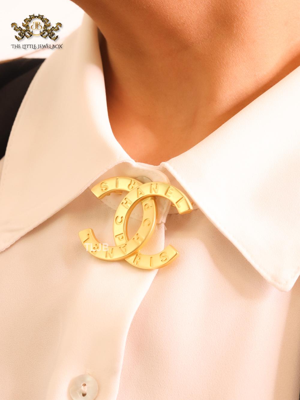 Double C embossed gold brooch