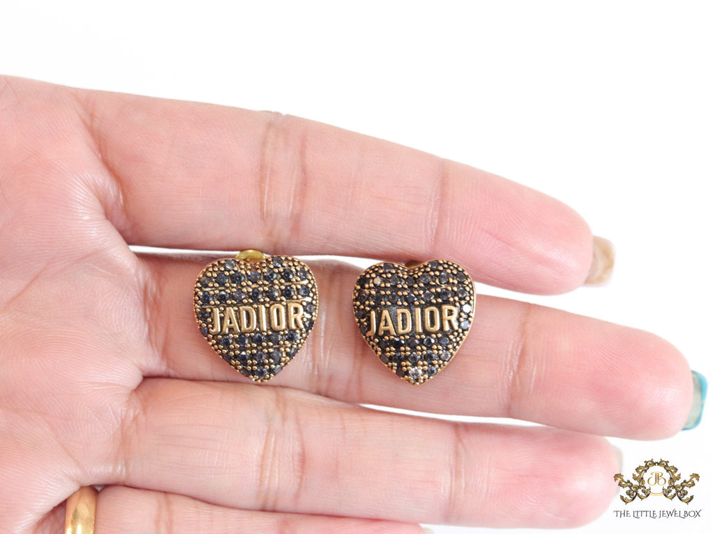 Heart shaped alphabet stud earrings in golden and black finish