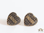Heart shaped alphabet stud earrings in golden and black finish