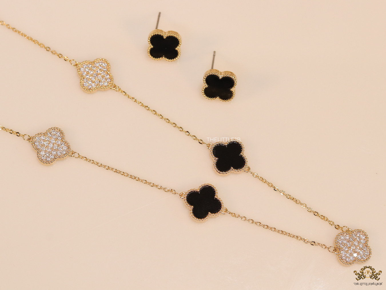 Gold plated necklace set with cz and black enamel coated clovers