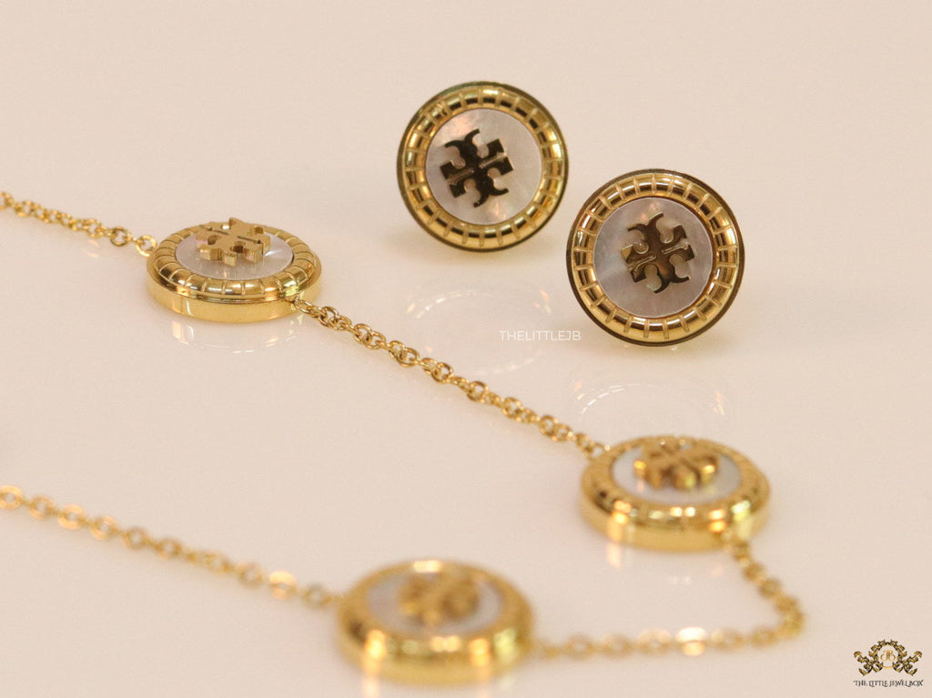 Gold plated necklace set with T motif mother of pearl discs