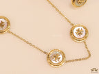 Gold plated necklace set with T motif mother of pearl discs