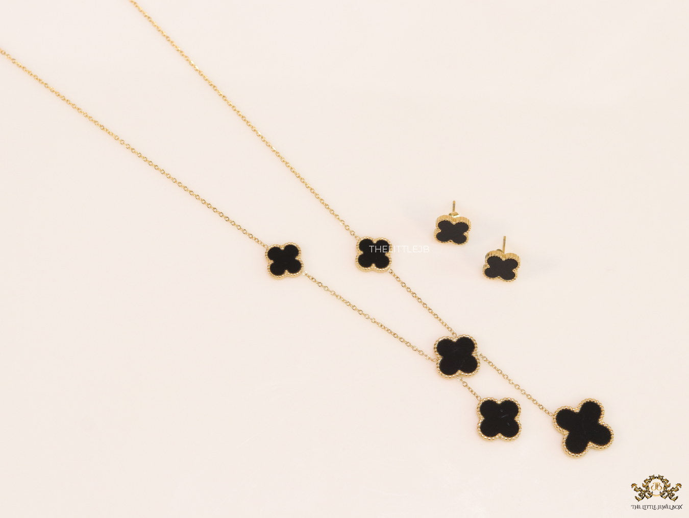 Gold plated necklace set with black enamel coated clovers