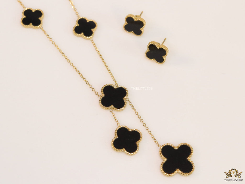 Gold plated necklace set with black enamel coated clovers