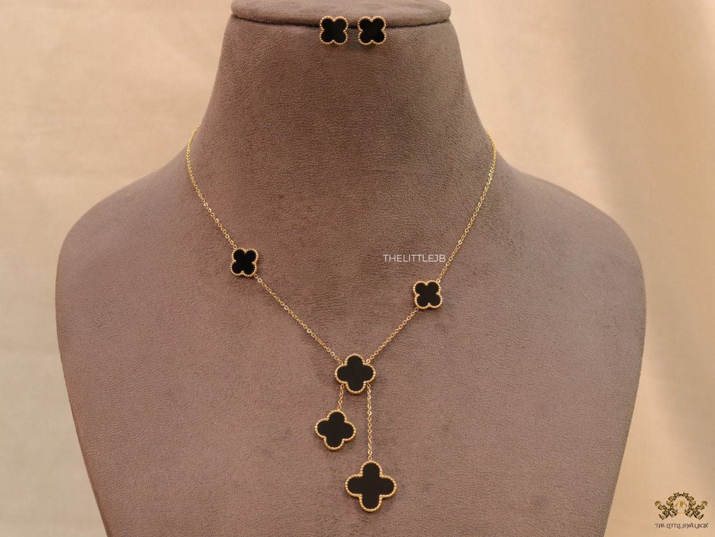 Gold plated necklace set with black enamel coated clovers