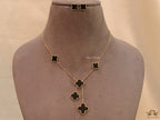 Gold plated necklace set with black enamel coated clovers