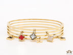 Multilayered golden bracelet with alphabets and coloured clover charms