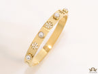 Golden bracelet with pearls and twin T cutwork