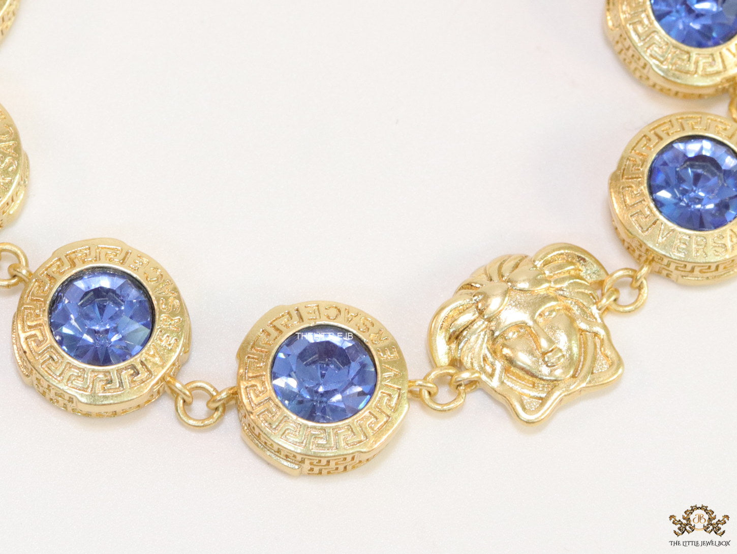 Designer golden Medusa chain bracelet with fancy cut cz