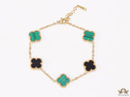 Golden chain bracelet with black and green clovers