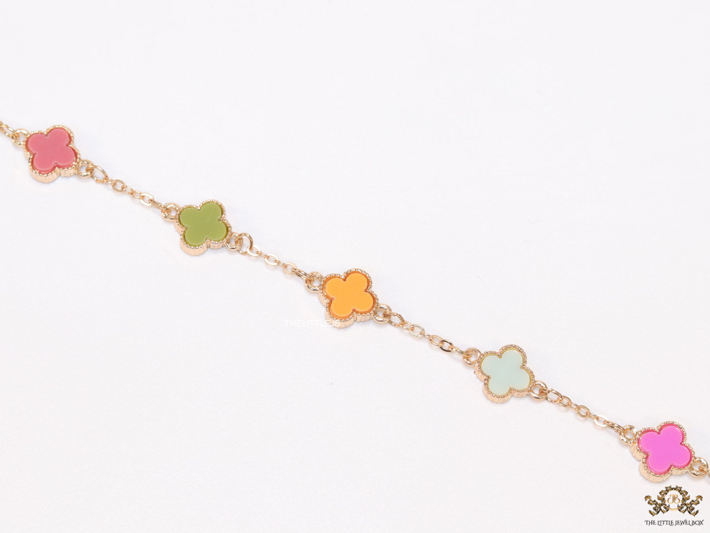 Golden chain bracelet with multi colored clovers