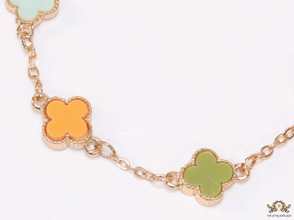 Golden chain bracelet with multi colored clovers