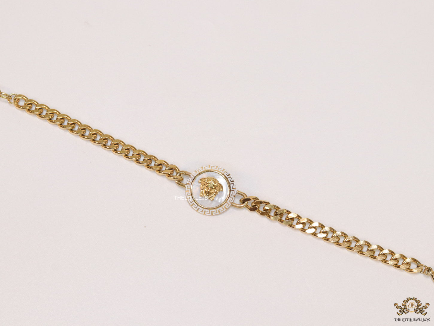 Golden link chain bracelet with Medusa motif centre