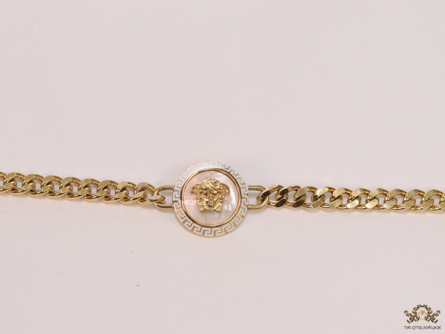 Golden link chain bracelet with Medusa motif centre