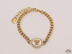 Golden link chain bracelet with Medusa motif centre