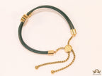 Adjustable double string green bracelet with twin T motifs