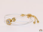 Adjustable double string white bracelet with twin T motifs