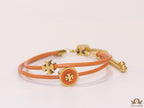 Adjustable double string orange bracelet with twin T motifs