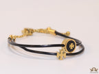 Adjustable double string black bracelet with twin T motifs