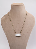 Double C enamel Bag on a black and gold chain