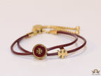 Adjustable double string maroon bracelet with twin T motifs