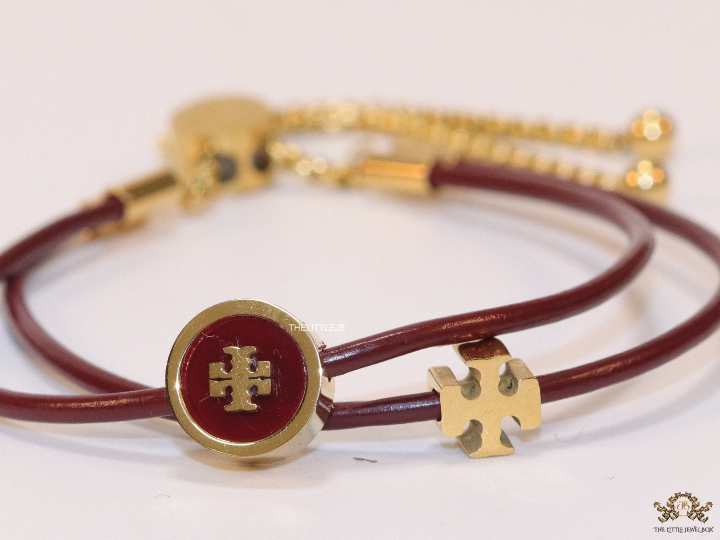 Adjustable double string maroon bracelet with twin T motifs