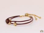 Adjustable double string maroon bracelet with twin T motifs
