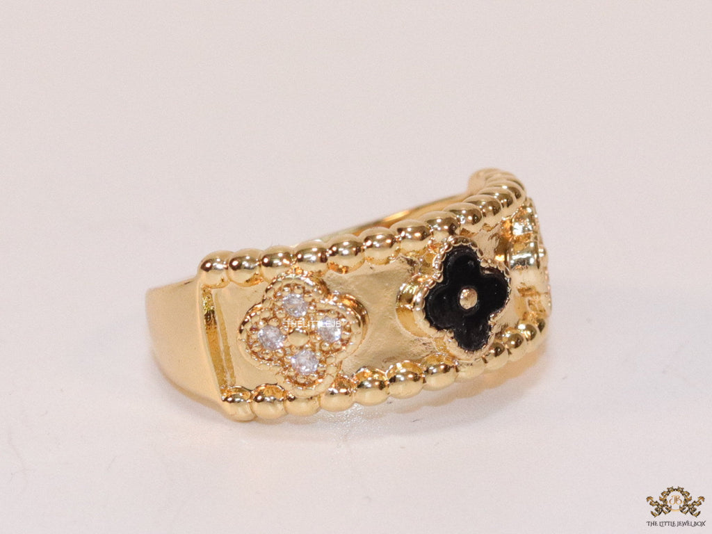 Golden ring band with black enamel and cz clovers
