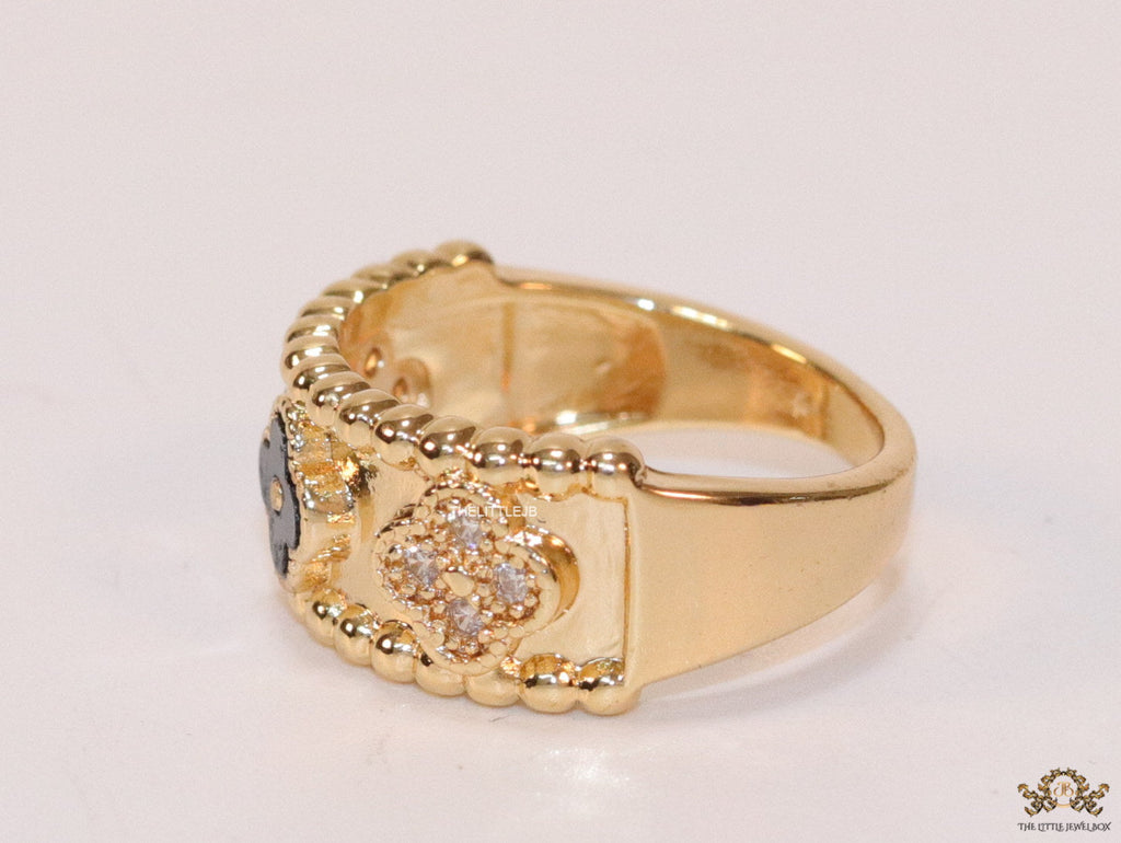 Golden ring band with black enamel and cz clovers