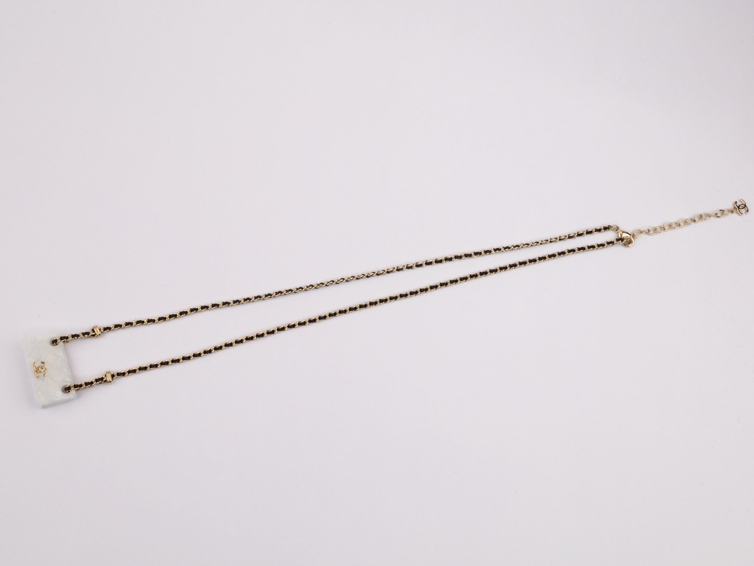 Double C enamel Bag on a black and gold chain