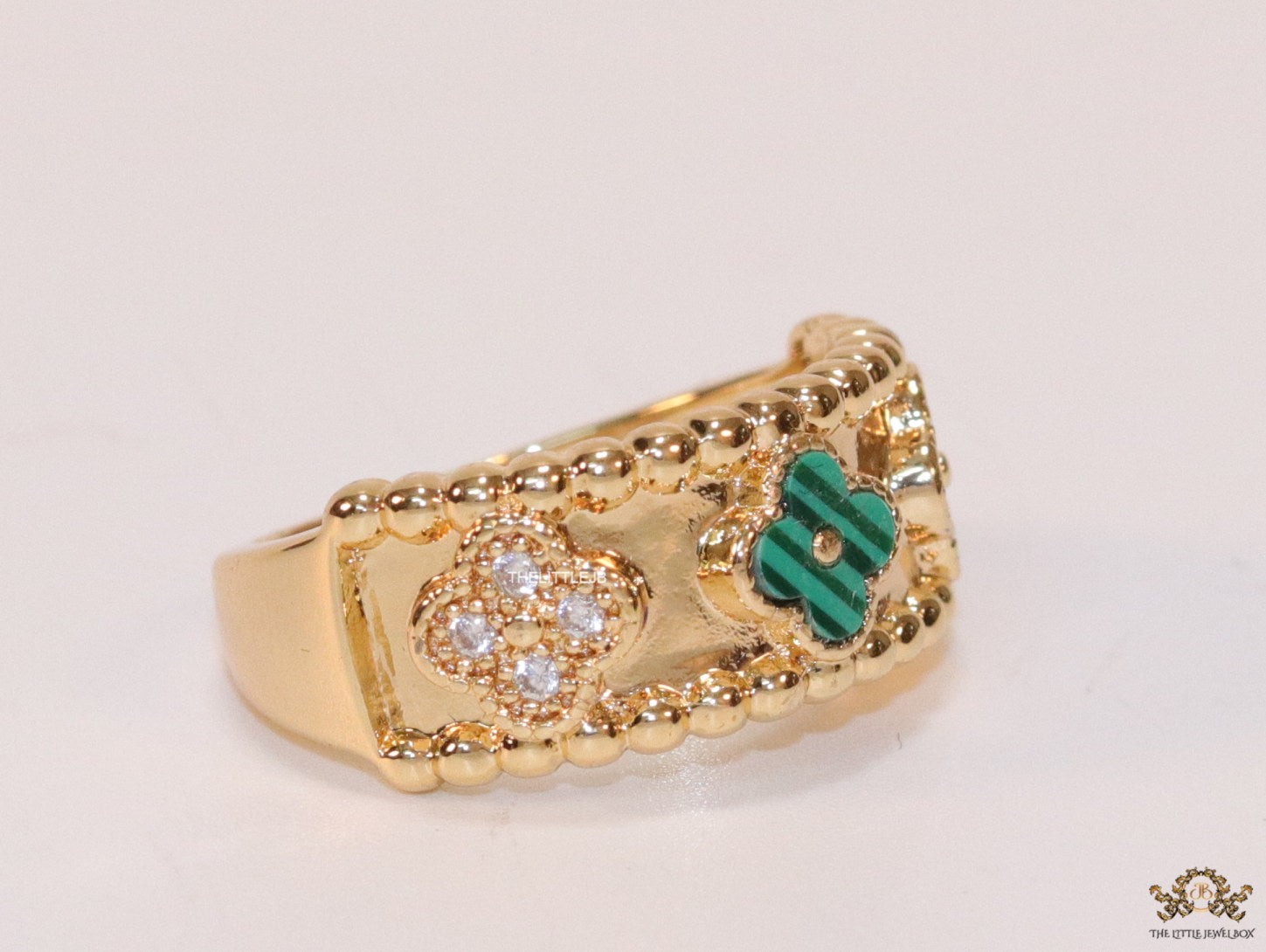 Golden ring band with malachite green and cz clovers