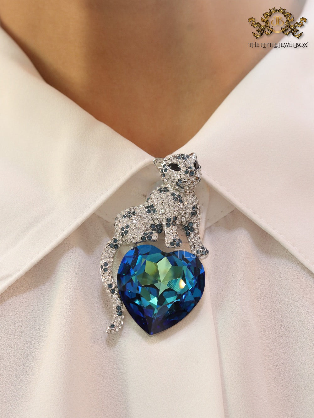 Panther on heart-shaped London blue topaz brooch