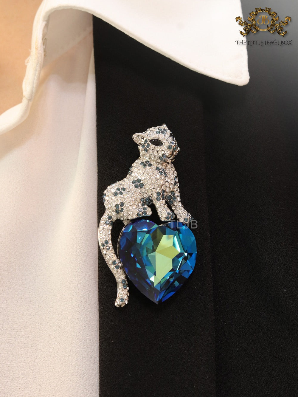 Panther on heart-shaped London blue topaz brooch