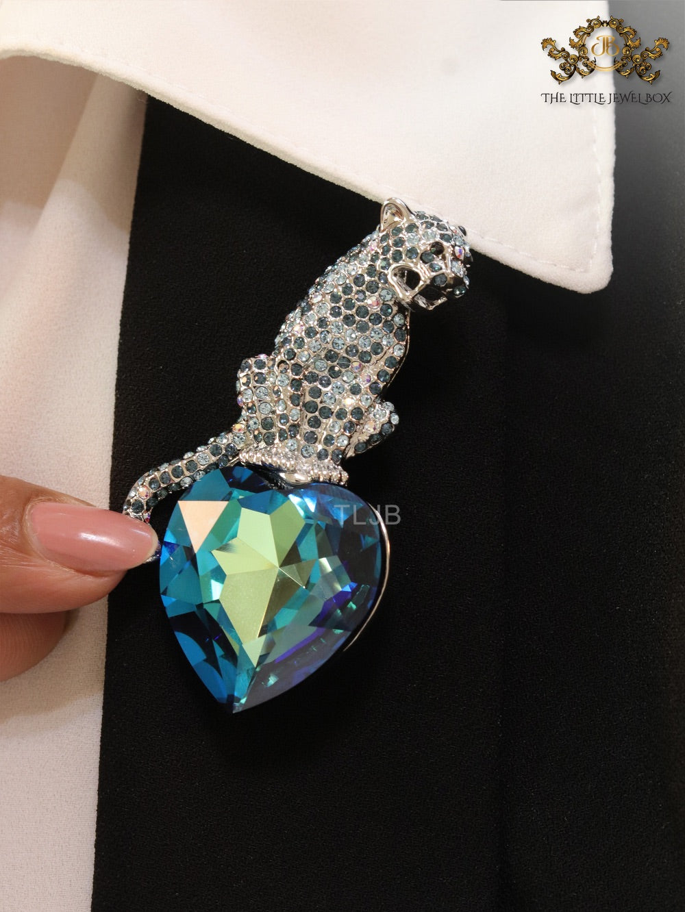 Inverted panther on heart-shaped London blue topaz brooch