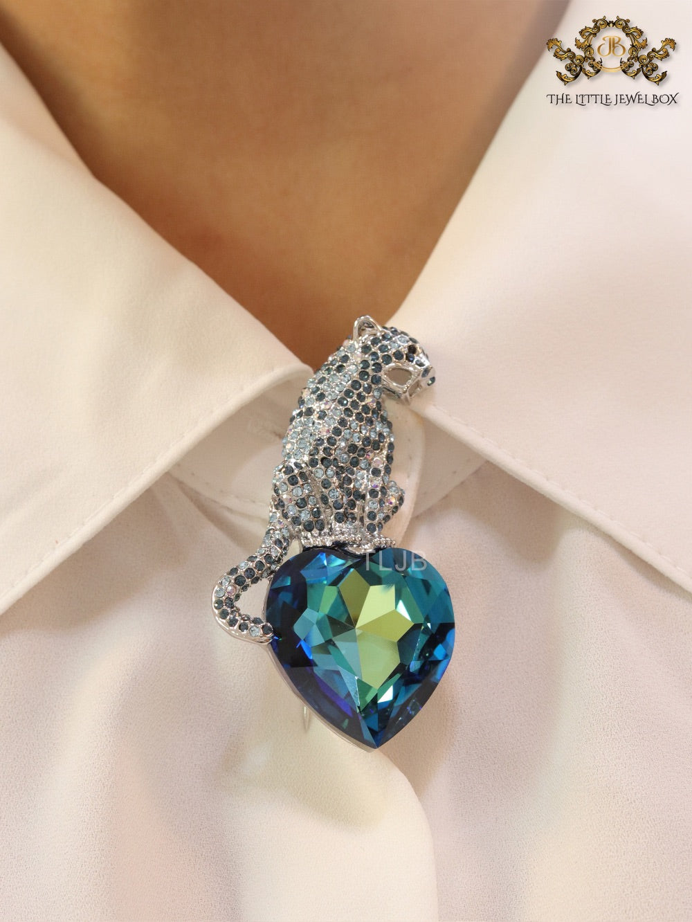 Inverted panther on heart-shaped London blue topaz brooch