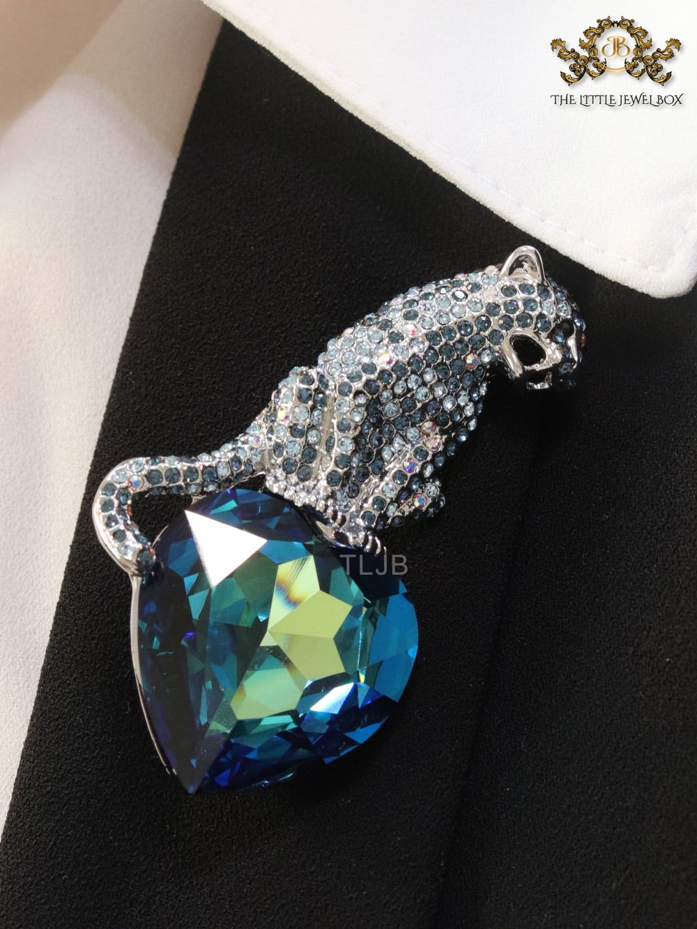 Inverted panther on heart-shaped London blue topaz brooch