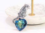 Inverted panther on heart-shaped London blue topaz brooch