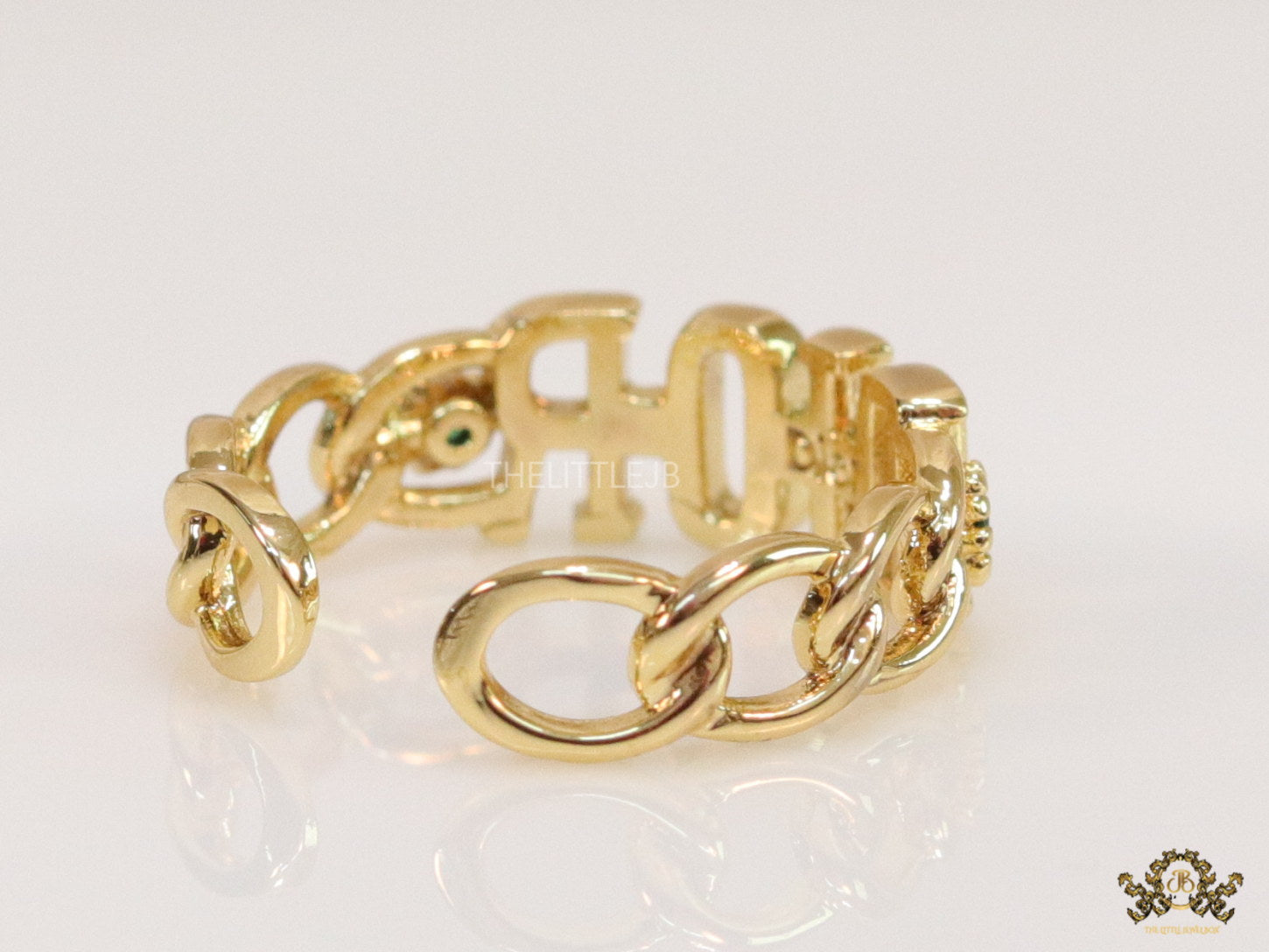 Gold plated alphabet open ring with green cz