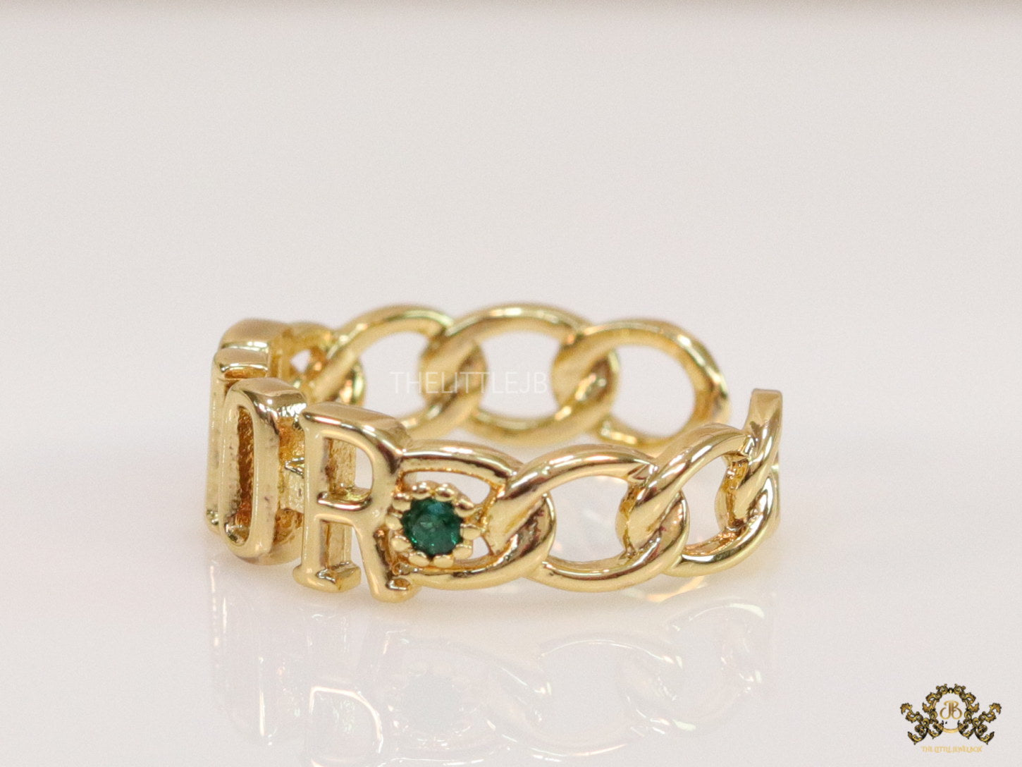Gold plated alphabet open ring with green cz