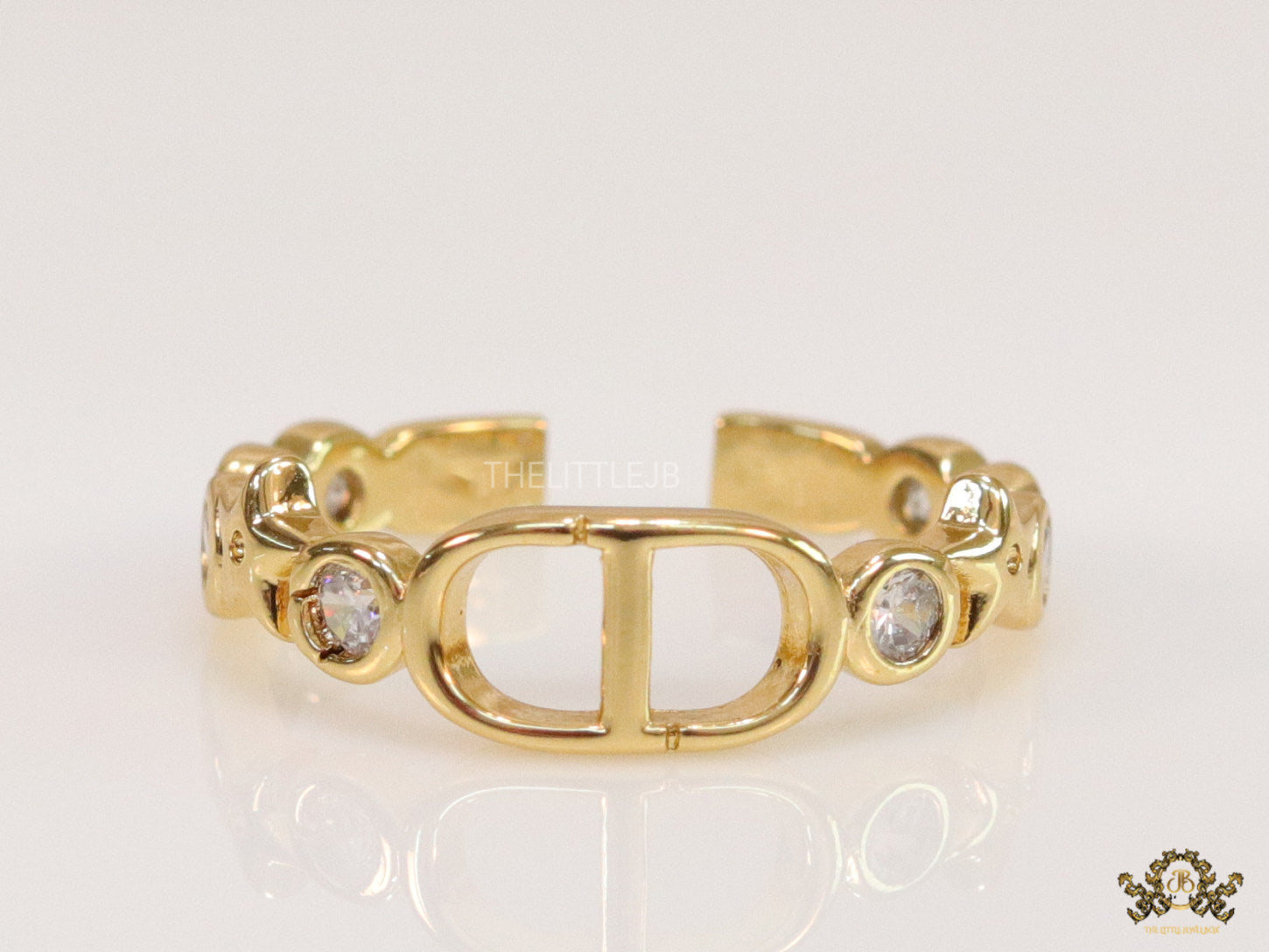 Gold finish alphabet open ring with white cz