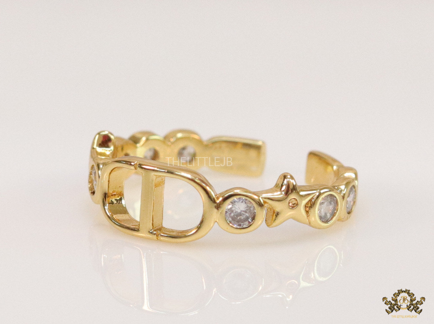 Gold finish alphabet open ring with white cz