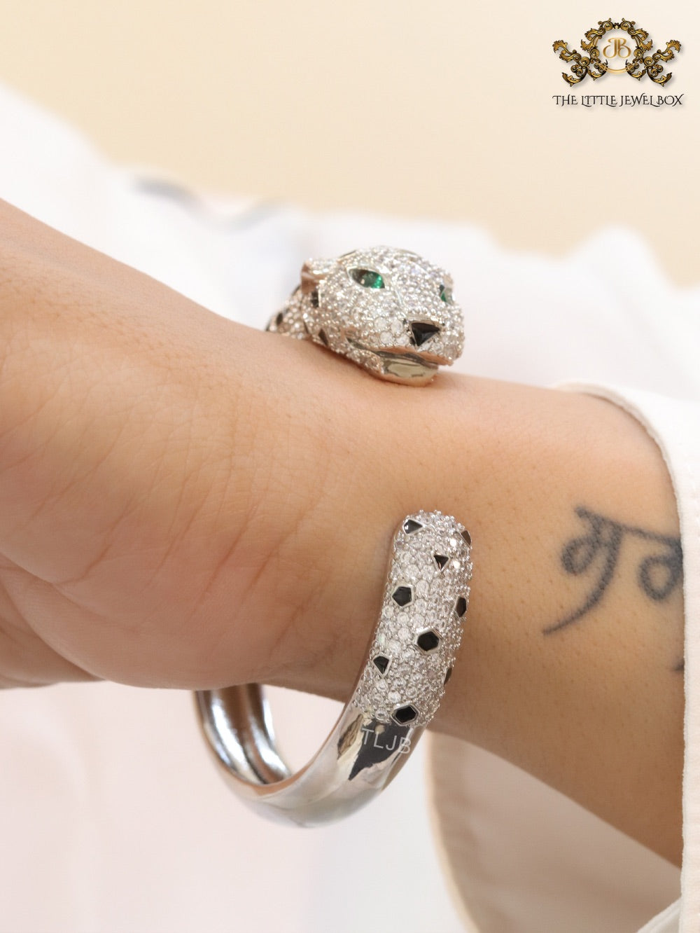 Panther cz platinum bracelet with emerald green stones